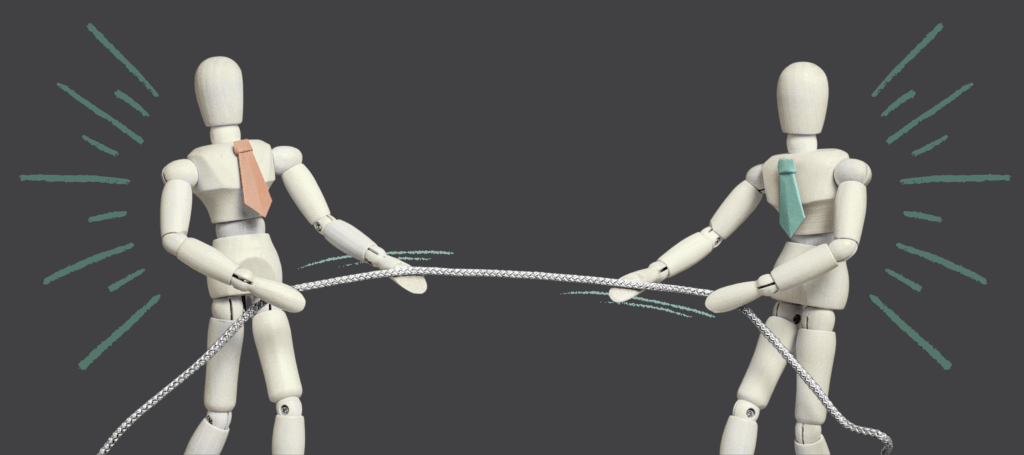 Two wooden figures wearing ties play tug of war with a piece of string.